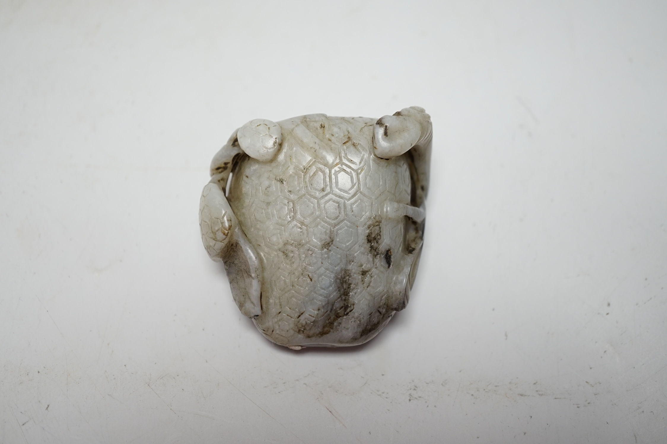 A Chinese carved white and black jade fruit shaped snuff bottle, 6cm high